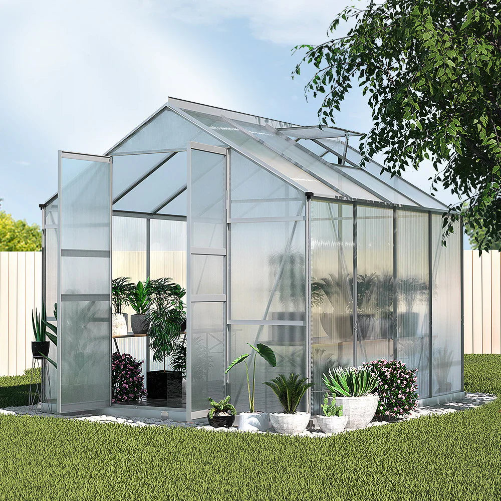 Large walk-in polycarbonate greenhouse with aluminium frame, double doors, and plants inside for backyard gardening – Bar Stool Centre Australia.